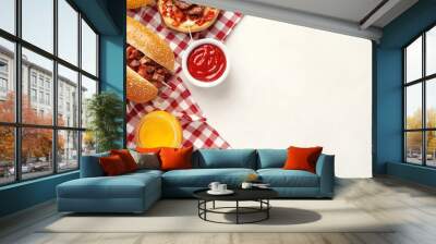 Delicious picnic spread featuring hot dog, grilled meat, fresh tomato, mustard, and ketchup on a red checkered tablecloth. Wall mural