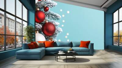 Festive Christmas tree adorned with red and white ornaments, set against a soft blue backdrop, evoking holiday cheer. Wall mural