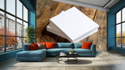 Two stacks of blank white paper on a rustic wooden table, perfect for note-taking or artistic projects. Wall mural