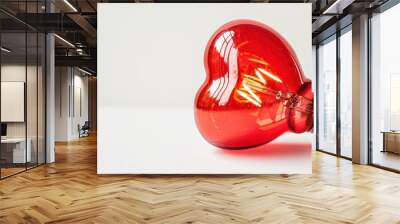 A glowing red heart-shaped light bulb against a white background Wall mural