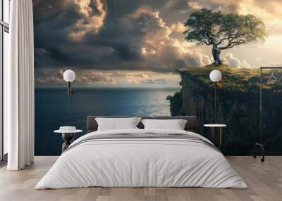 A solitary tree atop a cliff, overlooking the ocean beneath a stormy sky, as the sun descends Wall mural