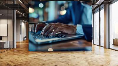 Businessman hand work on capable laptop computer at office table close up shot and selective focus at middle section of laptop computer keyboard while typing and working Wall mural