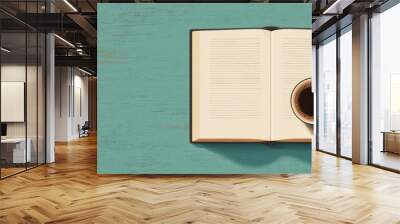 A book is open on a table with a cup of coffee next to it Wall mural