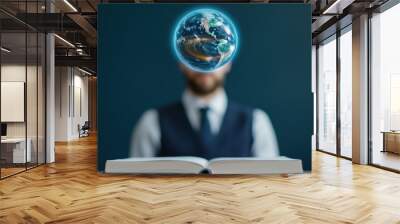 A man is sitting at a table with an open book in front of him Wall mural