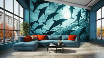 A captivating underwater scene, with a school of dolphins playfully leaping and frolicking in the ocean, their silhouettes dancing against the sunlit surface. Wall mural