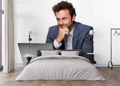 A happy businessman in the office sits and works on a computer or laptop on a white background. Wall mural