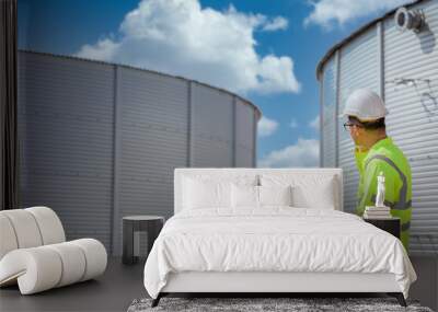 A male engineer is working on design controls via a laptop or notebook in an engineering factory. utilities Sewers and central wastewater treatment plants Wall mural