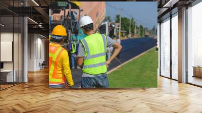 Asian architectural engineer working at road construction site For working on road construction sites and inspecting the development of paved road construction projects. Wall mural