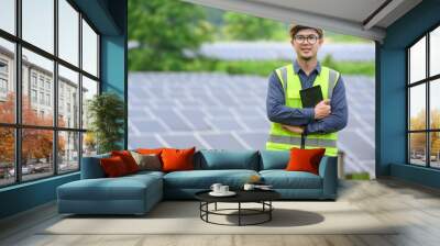 Asian male engineer Work with solar panels and install solar panels at photovoltaic power stations working on industrial solar energy storage. Wall mural