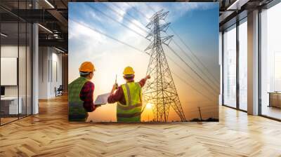 Picture of two electrical engineers checking electrical work using a computer standing at a power station to see the planning work at high voltage electrodes. Wall mural