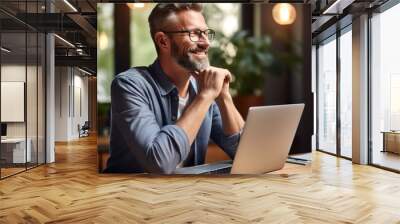 Project manager or experienced businessman Sitting and working on his computer or laptop happily in the office feels relieved and comfortable. Wall mural