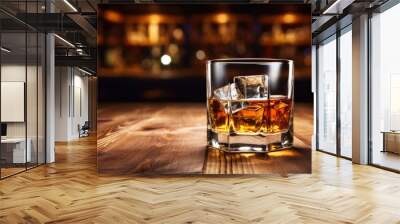 Whiskey with ice on wooden table in liquor store or bar counter with empty copy space Wall mural