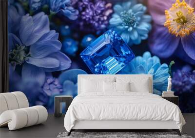 A vivid blue sapphire glowing with brilliance, framed flowers Wall mural