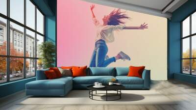 Woman leaping in the air with a colorful background Wall mural