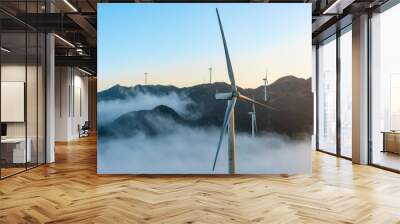 The mountain wind turbines in the sunrise and sunset in the sea of clouds Wall mural