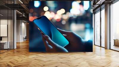  Close-up of hands holding an Phone with blurred city lights in the background, showcasing mobile device interaction for business or social media in a modern urban setting Wall mural