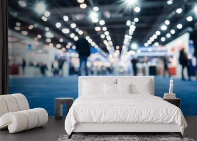 Blurred background of business fair or exhibition hall with lights and people on a blue carpet floor at event venue, captured using a Nikon D850 with 24-70mm f/2.8 lens. Wall mural