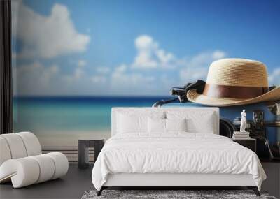 Suitcase, hat, and camera on a wooden table with a beach background, featuring copy space on the right side. Wall mural