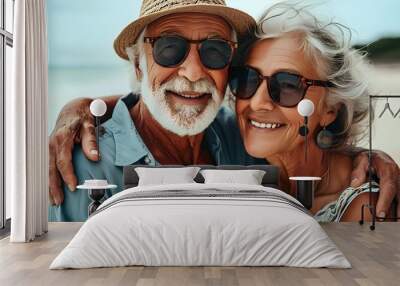 Carefree senior couple enjoying beach life and each others company in retirement bliss Wall mural