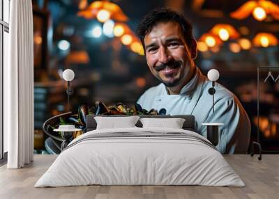 Cheerful male chef presenting a substantial bowl of fresh mussels in an inviting, softly lit restaurant ambiance Wall mural