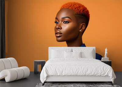 Chic fashion model showcasing vibrant orange makeup and a short hairstyle, dressed in a sharp blue suit against a sleek blue studio backdrop Wall mural