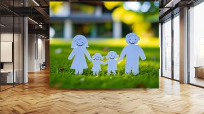 Closeup of paper cut family figurine on lush green grass by modern house with softly blurred background Wall mural