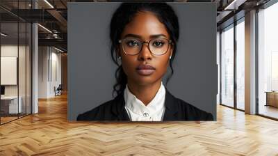 Confident black woman lawyer in glasses, portrait on gray background, ready for court case, embodying strength and professionalism in legal representation Wall mural