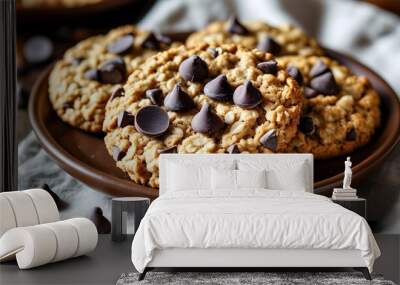 Delicious homemade chocolate chip oatmeal cookies beautifully arranged on a rustic brown plate Wall mural