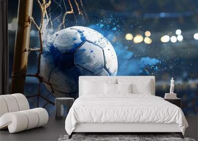 Dynamic moment of a soccer ball hitting the net, creating an explosion of blue powder surrounding the action Wall mural