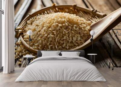 Elegant display of brown rice in a bamboo colander with a wooden spoon, set against a rustic wooden background, illuminated by soft backlighting Wall mural