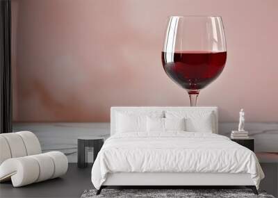 Elegant glass of red wine on polished marble countertop with a blurred background ambiance Wall mural