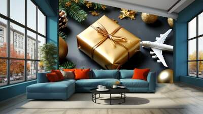 Elegant holiday gift arrangement with gold wrapping, festive decorations, and a toy airplane representing travel adventures Wall mural