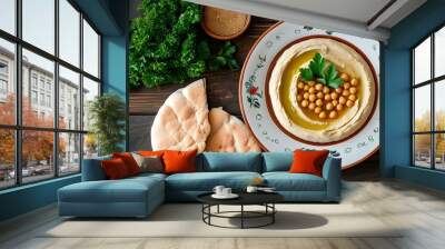 Elegant plate of classic hummus garnished with fresh parsley accompanied by warm pita bread, shot from a horizontal top angle Wall mural