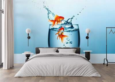 Goldfish leaping into a glass of water, representing freedom and adventure against a vibrant blue backdrop Wall mural