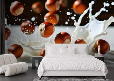 Hazelnuts in mid-air diving into a splash of milk captured in slow motion Wall mural