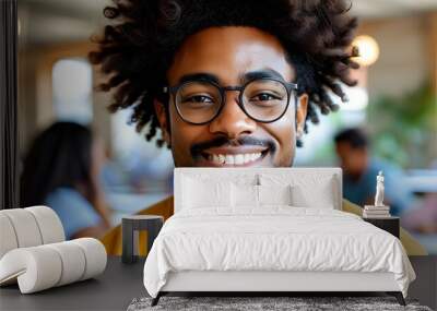 Joyful African American man in glasses engaging in a vibrant classroom setting, embodying positivity and multicultural interactions in a lively social environment Wall mural