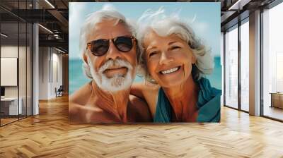 Joyful seniors embracing seaside bliss in their golden years Wall mural