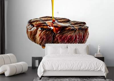 Savory grilled beef steak with rich sauce drizzling from a fork, set against a clean white backdrop. Wall mural