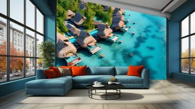 Serene aerial view of a tropical resort featuring thatched villas nestled in crystal blue waters Wall mural