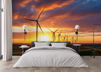 Serene sunset over a field of wind turbines bathed in golden light Wall mural