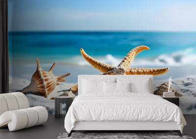 Starfish and conch shells resting on white sand with a backdrop of clear blue sea water Wall mural