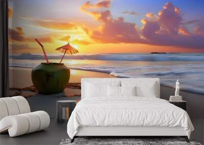 Tropical sunset scene featuring a coconut drink with straw on sandy beach, perfect for vacation and travel themed designs Wall mural