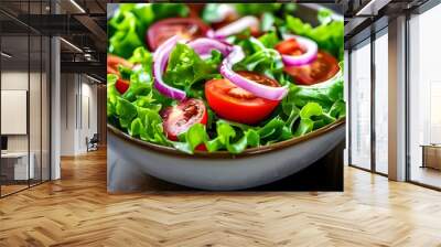 Vibrant bowl of fresh salad featuring crisp lettuce, juicy tomatoes, and zesty red onion for a healthy and delicious meal Wall mural