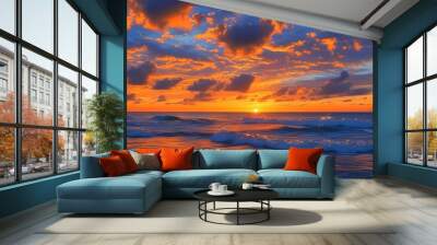 Vibrant sunset over the sea with orange hues reflecting on waves under a serene sky filled with scattered clouds, capturing natures picturesque beauty Wall mural