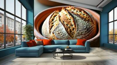 Warmly baked whole wheat sourdough resting in a rustic clay pot, capturing the essence of homemade comfort and wholesome goodness Wall mural