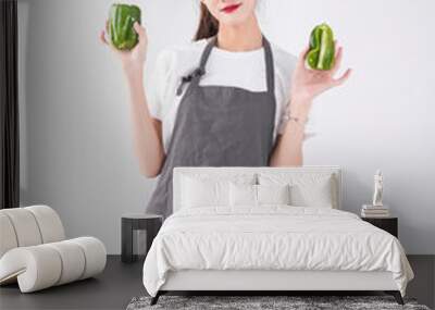 A woman with a vegetable in her hand Wall mural