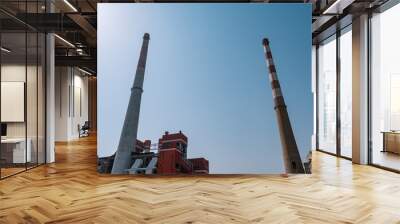 Looking up at the two chimneys of the factory Wall mural