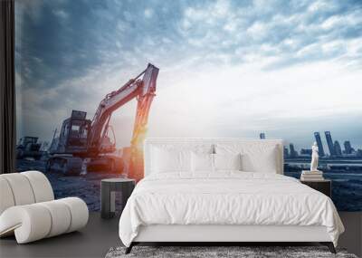 excavator in construction site on sunset sky background Wall mural