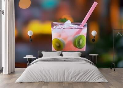 A refreshing drink with red liquid and green plum in the cup, paired with a pink straw, and a blurred background. Wall mural