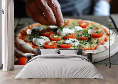 Artisan hands crafting a delicious pizza topped with fresh mozzarella, juicy tomatoes, and fragrant herbs Wall mural